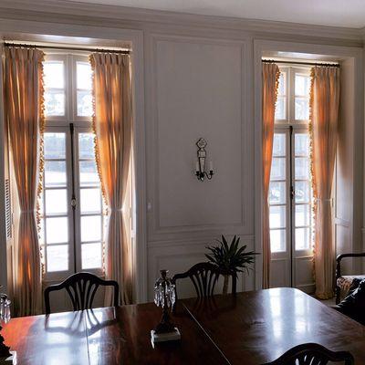 Repurposed silk lined and interlined curtains with fringe soften up a gorgeous dining room.