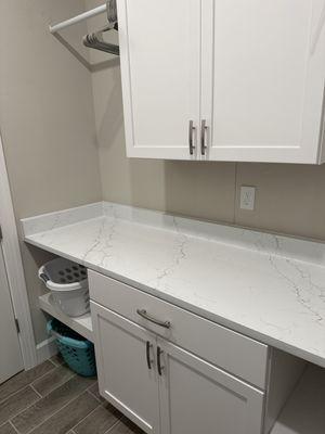 Laundry room quartz folding counter.