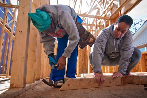 Homeowners complete sweat equity by helping to build their home