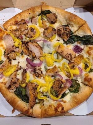 White Pizza with spinach, onion, banana pepper, and chicken added.