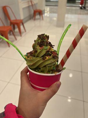 Soft serve matcha with choice of fruit pebble toppings with Oreo and wafer roll