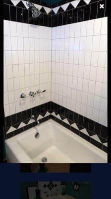 Subway tiles used vertically for a different look. Custom faucet to match glossy black accent tiles.