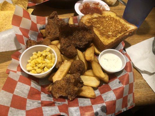 Catfish fish fry with fries, hush puppies, corn, garlic bread & tarter sauce.