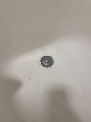 Beat up bathtub in a bathroom in need of a complete renovation.