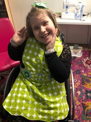 Maddy in her new apron sewn at Camp Giggle Stitch classes