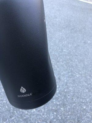 Side view of dented insulated stainless steel bottle.