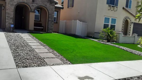 Artificial grass and stepping stones landscape project in front yard