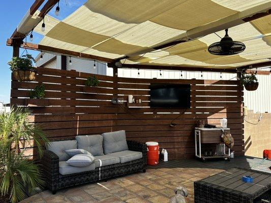 Covered pool patio with misters lights fan speakers and tv