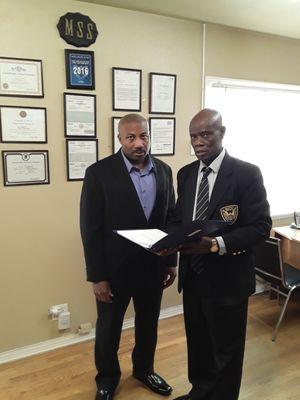 Mr. Mario Bickham (L) and Mr.  Paul I. Meaway (R) reviewing  Meaway Security Training Academy Training Courses.