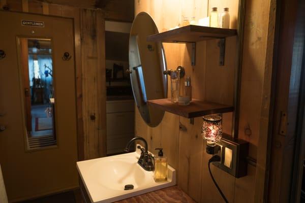 Bathroom is centered in the cabin with a washer and dryer space just beyond.