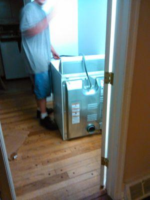 Josh set up a washer  machine as part of the move.