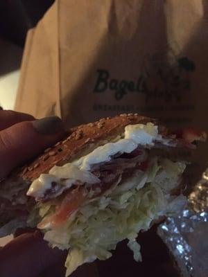 Scooped toasted sesame bagel with light cream cheese, bacon, shredded lettuce, tomato has my FULL attention... what love is