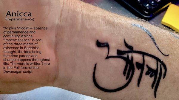 A tattoo of Tibetan (Pali) calligraphy which stands for "anicca" which means impermanence.