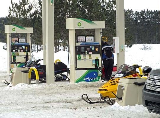 Snowmobiles pull right up to the pumps.