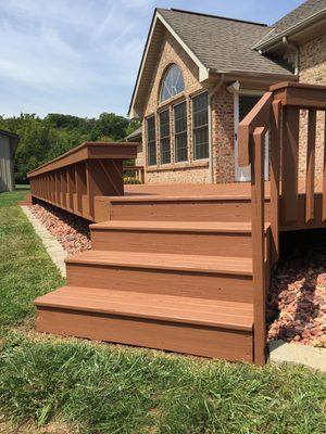 A deck after being sanded and solid stained