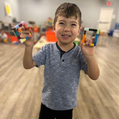 This Pre-K kiddos is proud of his creation of our shapes of the month: square!