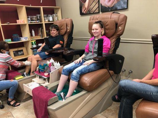 Those smiles! Carrie and Autumn are relaxing and having fun in the pedicure chairs