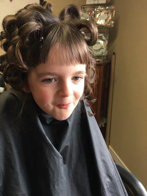 Flower girl getting her hair curled , such a sweet girl