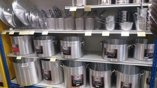 Stock pots. The one on the bottom left is 100 quarts!