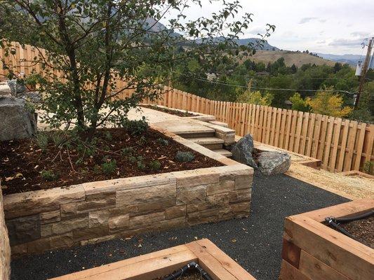 Stone walls, pathways, and timber planters