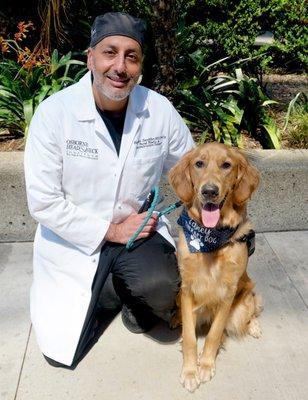 Dr. Hootan Zandifar with Laney the therapy dog for the Paws for Patients program at the Osborne Head and Neck Foundation.