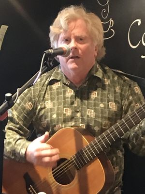 Mike Heilman at a local coffeehouse playing an original song