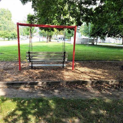 small swing bench near the statue