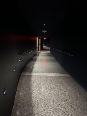 Well lit hallway to seating behind stage