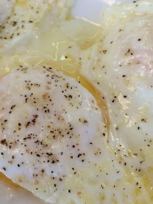 Slimy eggs, the egg whites on over easy eggs should be fully cooked, as soon as I cut into it, the middle oozed out