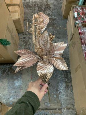 Winter holiday decorative poinsettia in rose gold