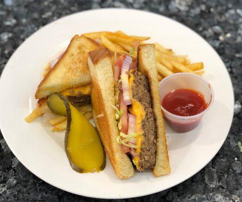 6oz all beef patty seasoned w/da Real Deal seasoning dressed to perfection served w/fries...