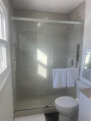 New walk in shower with ceramic mosaic floor tile & classic wall tile