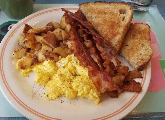 2 scrambled eggs, home fries with onions, bacon an wheat toast. Coffee.