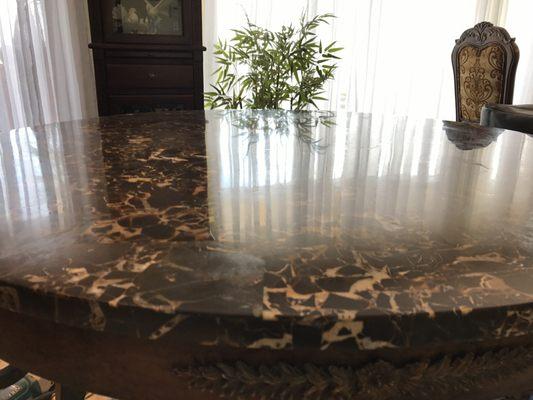 We polished this marble table to  the highest shine possible and removed the etch marks for our customer.