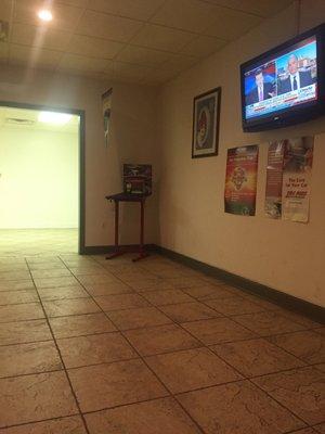 Waiting room. Pretty nice, couches, chairs, soda machine, and television. Also a kids room.