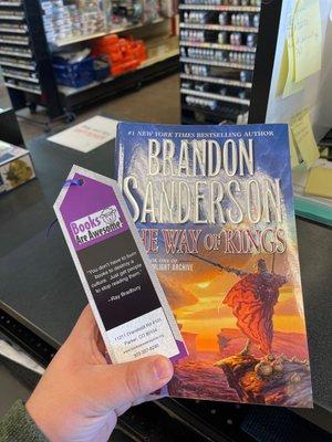 The way of kings by Brandon Sanderson and a bookmark from the Books are Awesome store.