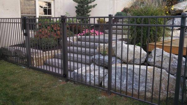 Adding even more curb appeal to this landscape with ornamental aluminum fence in a dark bronze powder coated finish