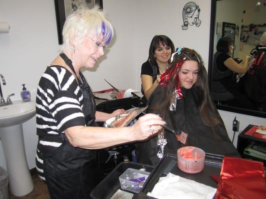 Edi and Aimee working on a head full of long, beautiful red highlights.