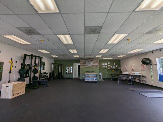 Our main area complete with our brand-new functional training equipment and physical therapy treatment corner.