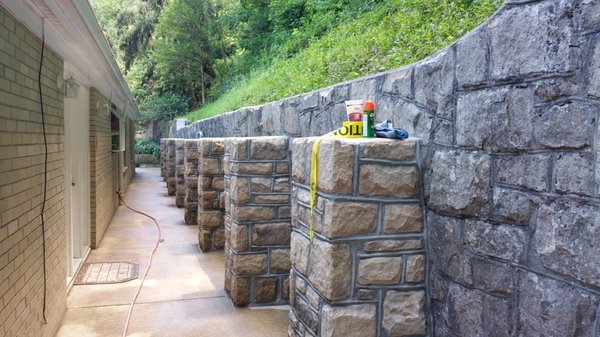 Stone buttress to stabilize badly leaning stone retaining wall