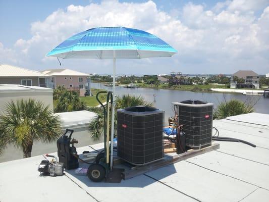 Here's how we stay cool on a 95F rooftop.  Notice the bottle of Nitrogen (for purging the refrigerant lines) and the vacuum p...