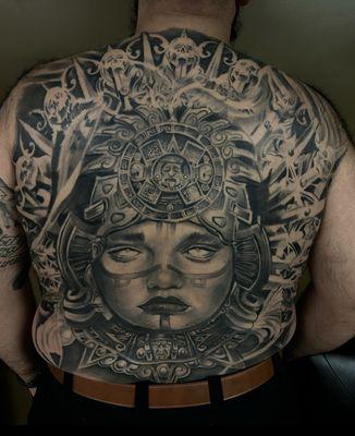 Healed culture back piece tattoo