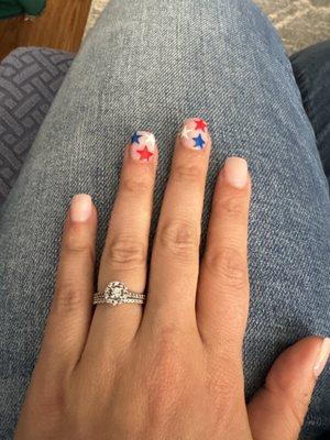 Acrylic nude nails with 4th of July stars.