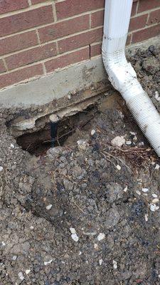 Soil removed and foundation exposed after repairs