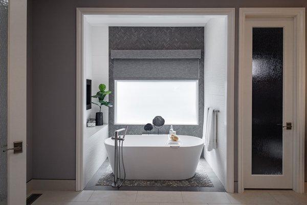 Stand alone soaking tub, pebbled floor, pass through fireplace all centered on a window with a view!