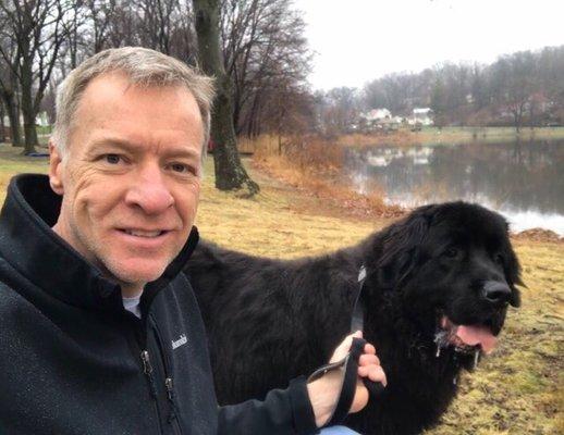 Ed walking our Newf by the lake across the street from his house