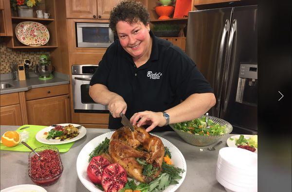 Kim carving a turkey during a feature on WLUK