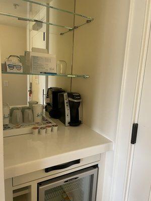 Sunset King coffee/fridge area with wine glasses