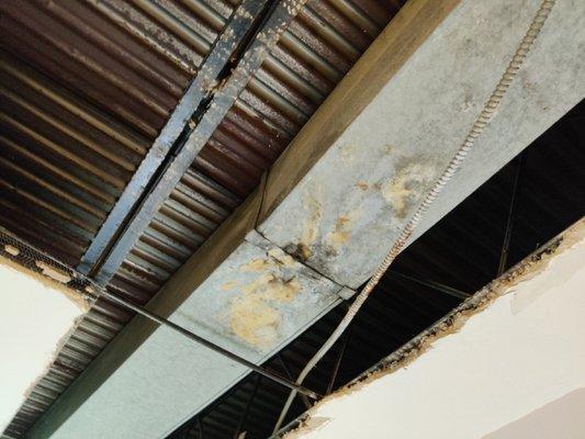 Ceiling collapsed due to uninsulated HVAC on EVERY UNIT ..revealed piles black mold. This needs condemned.