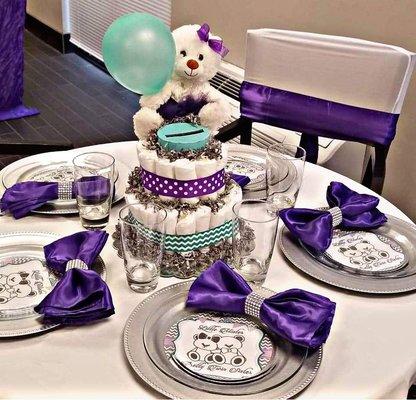 Table setup with wishing well diaper cakes